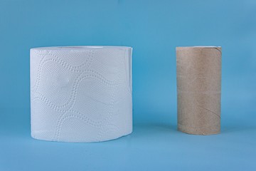 close up of full end empty rolls of white toilet paper on blue background. copy space for text. hygiene concept 