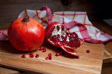 Fresh red pomegranate on a wooden background..
