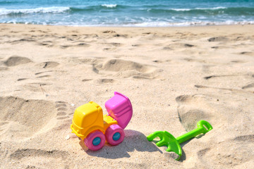 Fototapeta na wymiar Colorful Beach Toys at a Beach on a Sunny Day