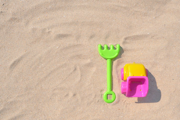 Fototapeta na wymiar Colorful Beach Toys at a Beach on a Sunny Day