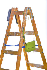 Step ladder fashion concept. Green bag. Fashion and career. The interaction of things. Fashionable bag and building ladder.