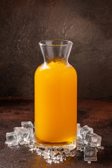 Delicious cold refreshing orange smoothie drink in cocktail glass