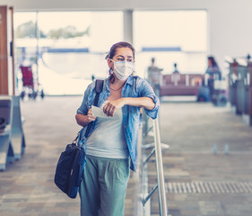 Traveler with mask stuck in airport no able to return home country due to COVID-19 border closures.