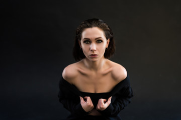 Portrait of beautiiful young woman on the black background.