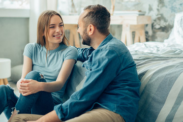 Relaxed couple having pleasant talk at home stock photo