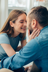 Fototapeta premium Happy loving couple nearly kissing and smiling stock photo