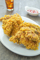 Ayam goreng crispy or fried chicken crispy on white plate.