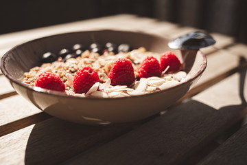 Healthy morning breakfast. Cereal bowl with berries and coffe