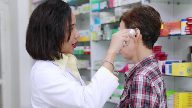 Doctor check ear fever detector patient in clinic Thailand 4k video 