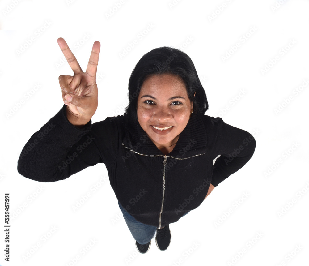 Wall mural woman making the victory sign on a white background