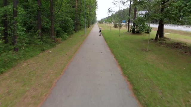 Child on a scateboard in a park.