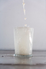 Throwing milk into a glass on a white background. Drink macro photography