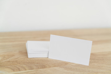 Blank business cards on wooden surface.