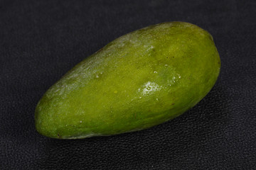 Green tasty mango over wooden background