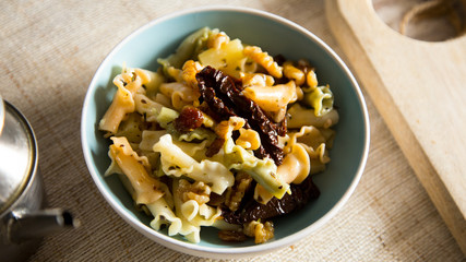Pasta salad with walnuts and dried tomato