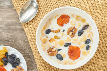 Corn bowl with fresh milk and dried fruits on the plate