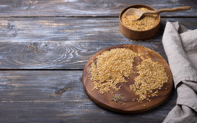 Golden flax seeds on wooden table. trash removal process. healthy vegan superfood. space, horizontal	