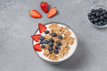Healthy breakfast. Whole wheat healthy cereals with fresh berry blueberry, strawberry and yogurt.