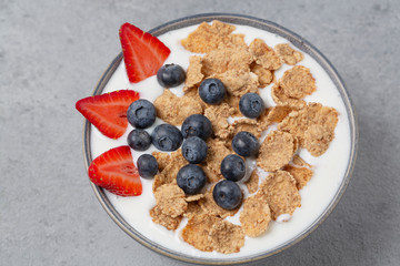 Healthy breakfast. Whole wheat healthy cereals with fresh berry blueberry, strawberry and yogurt.