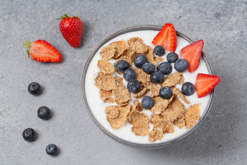 Healthy breakfast. Whole wheat healthy cereals with fresh berry blueberry, strawberry and yogurt.