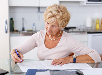 Senior woman filling up documents