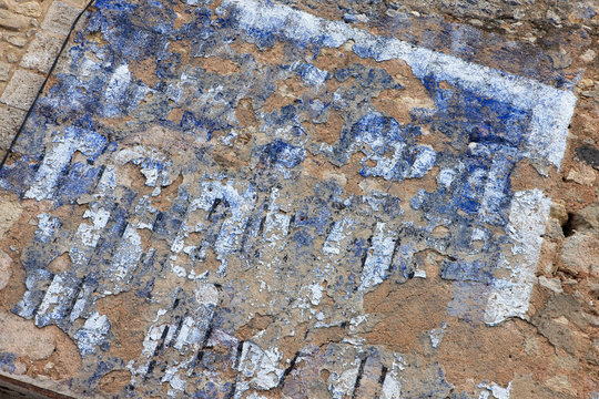 Faded wall painting advertising. Capestang Languedoc France