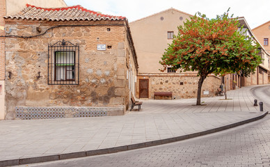 Fototapeta na wymiar View of the old streets in Toledo, Spain. Quiet stone pavemented street. Medieval cobbled city.