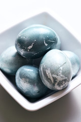 Easter blue-grey color eggs in the plate. Vertical poster.