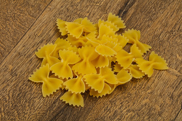 Fototapeta na wymiar Raw dry farfalle pasta for cooking