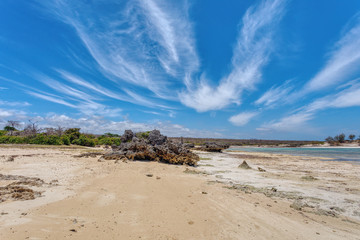 rocky beach in Antsiranana, low tide, Diego Suarez bay landscape, Madagascar beautiful pure nature with blue sky and water, Africa wilderness