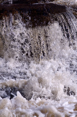 Fresh waterfall, white water with stones in close up scenic. The picture is taken in Bollebygd, Sweden.