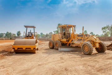 Motor grader and Vibratory roller compactor working in site construction. Road construction heavy equipment - obrazy, fototapety, plakaty