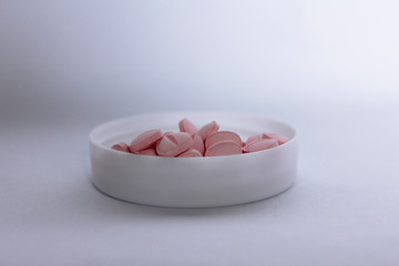 pink tablet in container