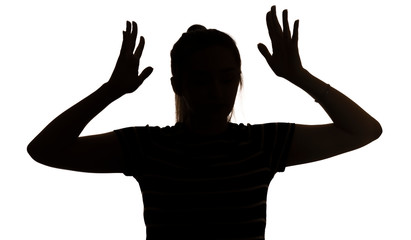 silhouette of a young woman with hands up in stress on a white isolated background, concept female emotions, fear and depression