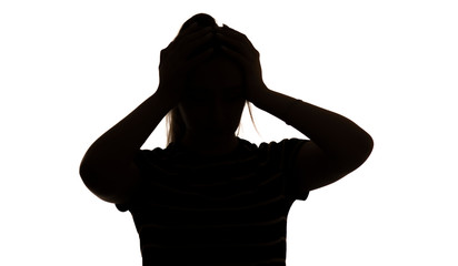 silhouette of a young woman in stress clasped her head on a white isolated background, concept...