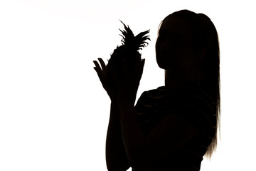 silhouette of woman figure with pineapple fruit in hands on white isolated background, concept vitamins and healthy food, female beauty
