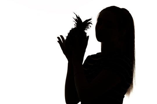 recommend clip art: silhouette of woman figure with pineapple fruit in hands on white isolated background, concept vitamins and healthy food, female beauty