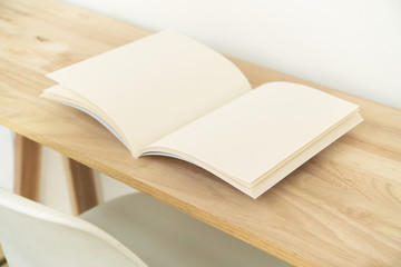 Blank catalog, magazines, book on wood background.