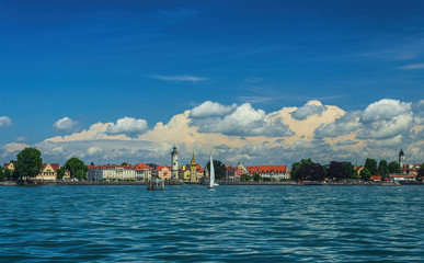 Fototapeta na wymiar The Lindau embankment, the New lighthouse, the Bavarian lion and the Mangturm tower. lake Constance. Germany. Soft focus, blurry background.