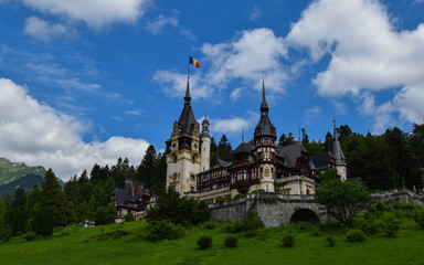 Fototapeta na wymiar Peles Castle is a masterpiece of German new-Renaissance architecture. Nestled at the foot of the Bucegi Mountains in the picturesque town of Sinaia, built as a summer residence of the kings of Romania