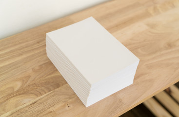 Blank catalog, magazines, book on wood background.