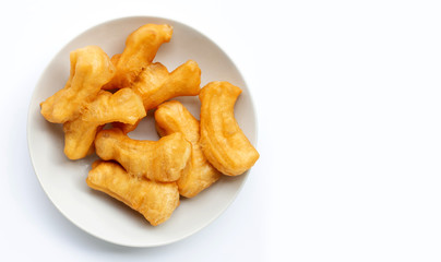 Deep-fried dough stick, chinese bread stick in white dish on white background.