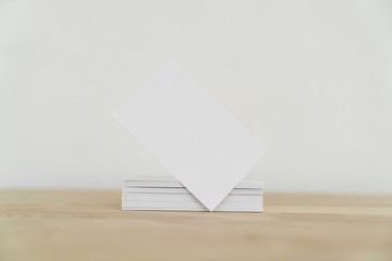 Blank business cards on wooden surface.