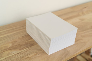 Blank catalog, magazines, book on wood background.