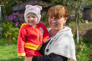 autumn portrait of mother with baby,mother with her daughter smiling in the autumn sun