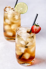 Gasses of Cold Citrus and Strawberry Ice Tea Decorated with Slice of Lemon and Strawberry Healthy Summer Drink Vertical