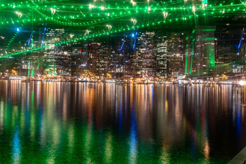 Brisbane CBD reflecting off the Brisbane River underneath the Story Bridge