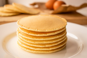 A stack of pancakes on a white plate