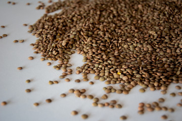 brown lentils on white surface