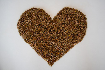 brown lentils on white surface heart shaped